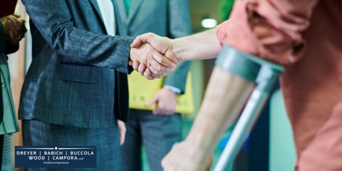 man in brace shaking hands with lawyer